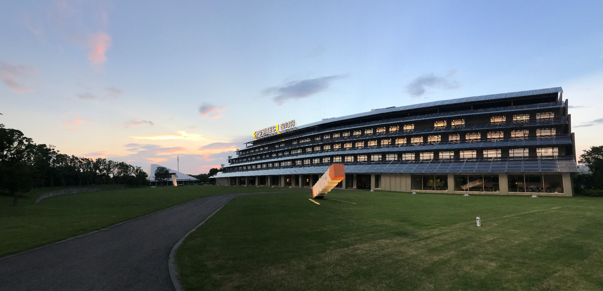 positec headquarters, featuring a sprawling lawn with sunset in the background